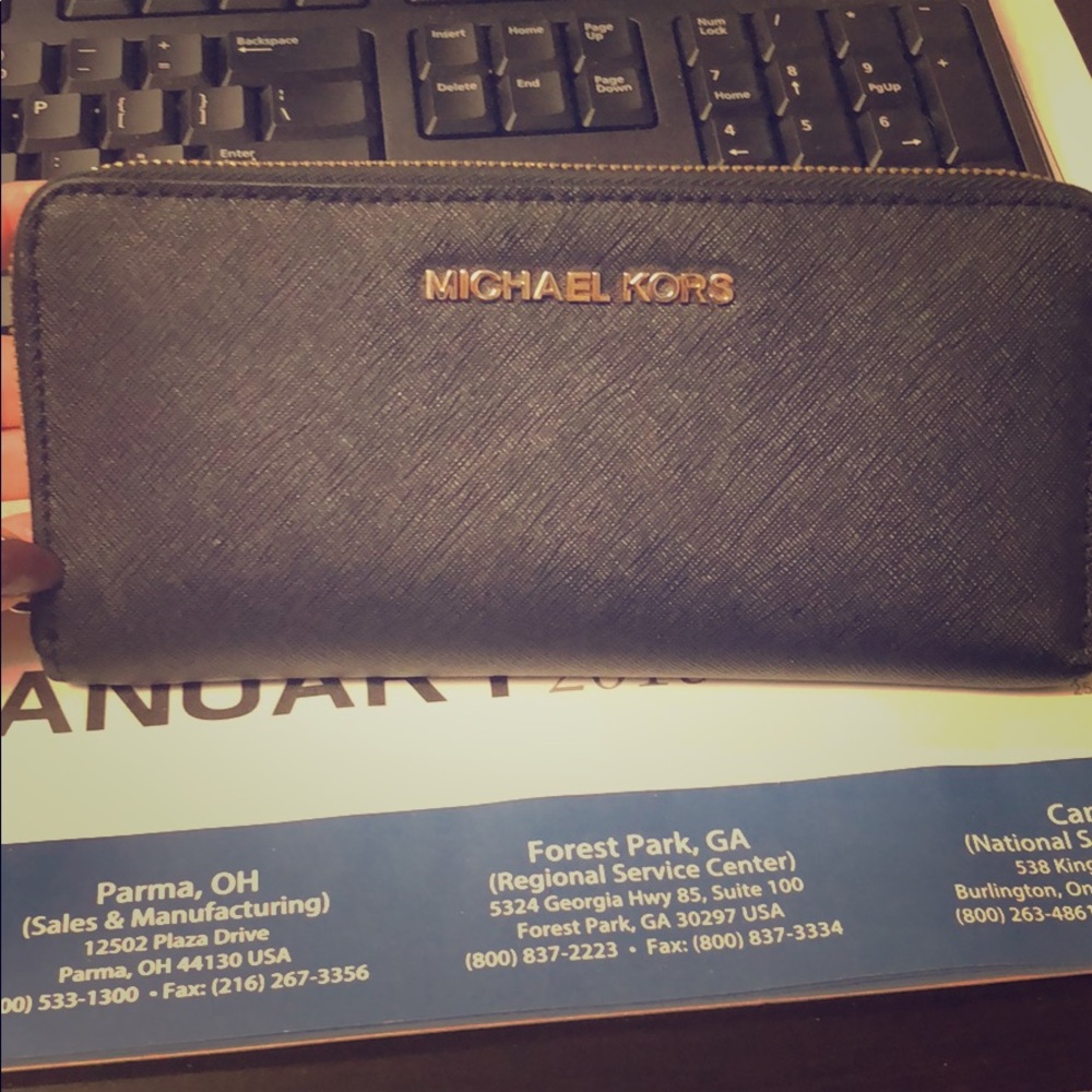 Michael Kors, Black wallet with gold hardware.